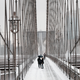 People walk through the snow on the Brooklyn Bridge in Manhattan on Jan. 7, 2022.